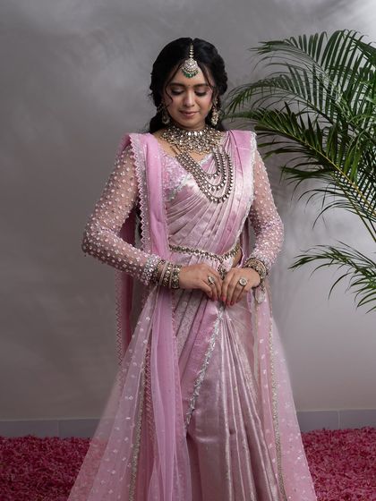 From my Maharani Series, this light pink Kanjivaram saree is where tradition meets modern artistry. I've adorned it with intricate zardozi and paired it with a net handwork blouse and a regal dupatta, a tribute to the ancient queens of India.