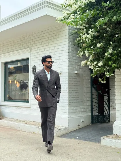 A full-length view of the pinstripe double-breasted suit, showcasing the flattering cut of the trousers and jacket.