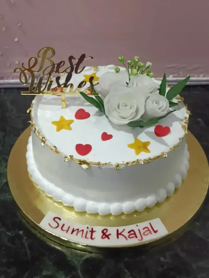 A simple and sweet "Best Wishes" cake. The heart shape and delicate white sugar roses make it perfect for an engagement, wedding, or any happy occasion.