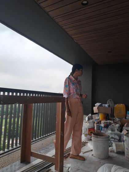 A realistic look at a site visit. It often involves navigating construction materials and visualizing art on unfinished walls.