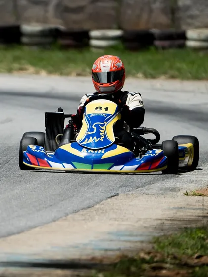 A solo shot of our driver in the number 81 kart, focused during a practice lap.
