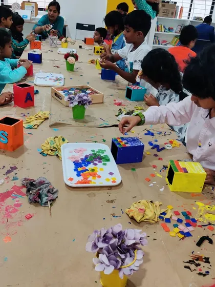 A bustling table of kids and moms from Tumkur enjoying a special art party combined with a magic show. We love hosting groups for unique events!