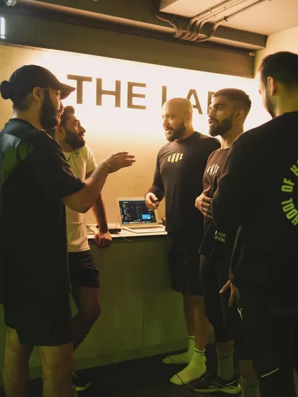 Our coaches gather at "The Lab" to plan a group class. This behind-the-scenes shot shows the collaboration and expertise that goes into every session.