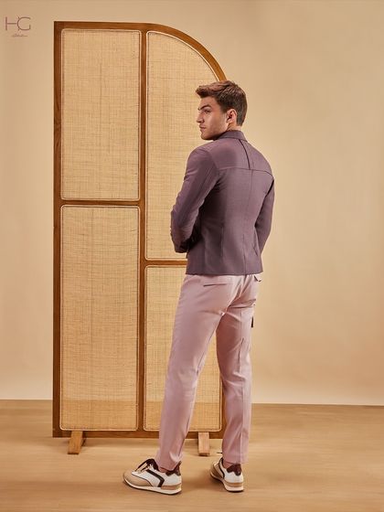 The back and side profile of the maroon shacket and pink trousers, highlighting the clean lines and contemporary tailoring.