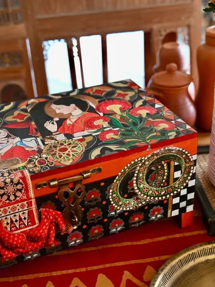 This memory box is styled in a home setting, showing how it can serve as a beautiful and functional catch-all. The artwork features vintage Indian portraits and ethnic jewelry designs.