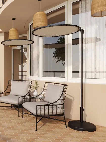 Modern outdoor lounge chairs are paired with unique standing shades, providing comfort and style for sunny afternoons.