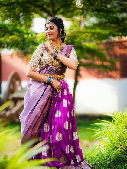 This pose captures the traditional essence of the outfit, perfect for a bride during her pre-wedding rituals.