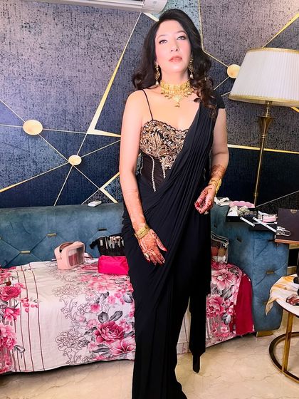 A confident pose showing off the full ensemble. The makeup is designed to make a statement while still looking elegant.