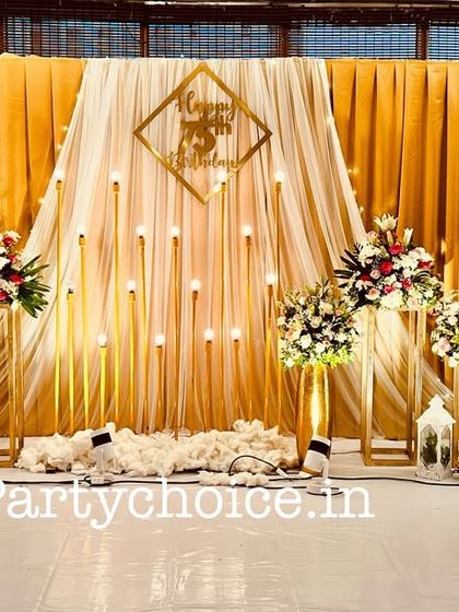 The full view of the elegant 75th birthday stage, complete with marquee numbers and ambient lighting.