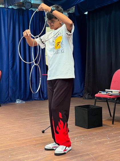 The classic linking rings illusion, performed with focus and flair by one of our talented students during a magic workshop.