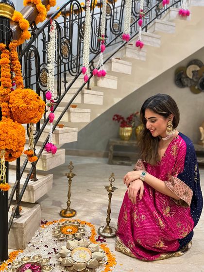 Sitting by the Diwali decorations. The flowy silhouette of the kaftan is perfect for a long evening of celebrations.