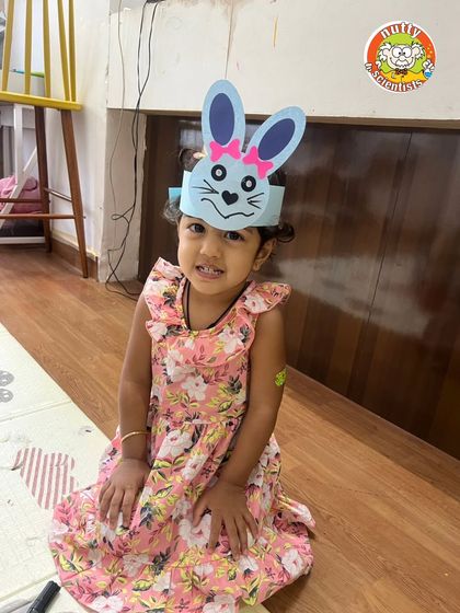 This little one looks adorable in her handmade bunny ears, a sweet souvenir from a fun-filled day at camp.