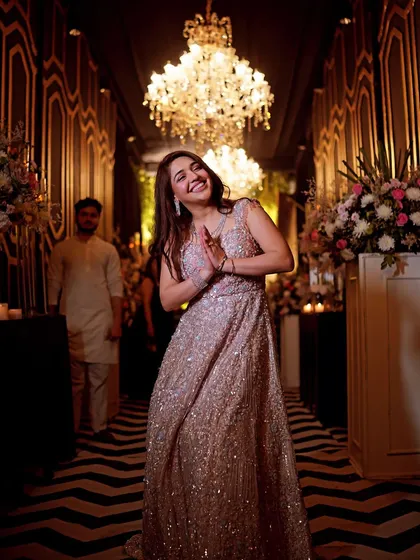 The joy of the dance floor. This bride's happy expression and graceful entry into the celebration hall make for a vibrant and lively portrait.