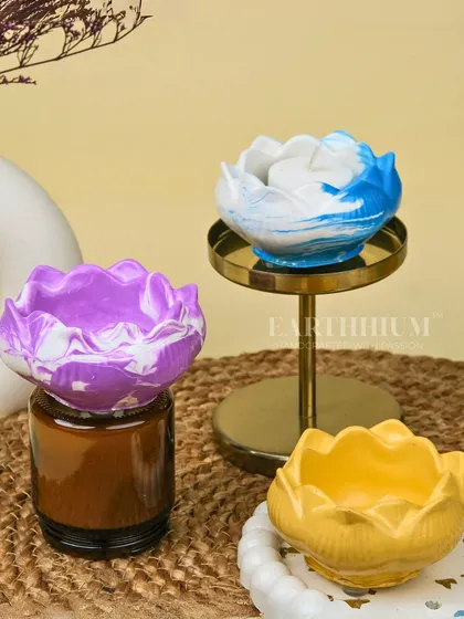 My Jesmonite tea-light holders in a lotus shape. I create them in various colors and marbled patterns, making each one a unique piece of art.