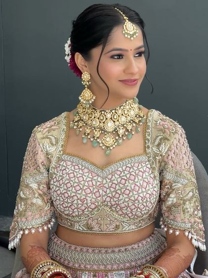 A close-up of Shrriya's wedding makeup. The soft pink eyeshadow and flawless skin create a look that feels both traditional and contemporary, perfectly matching her Gazal Gupta couture.