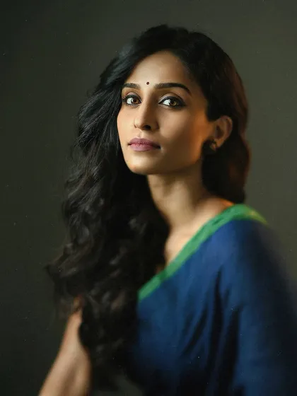 This shot has the feel of a classical painting. The simple composition, soft lighting, and the model's serene pose come together to create a portrait that is both elegant and powerful in its simplicity.