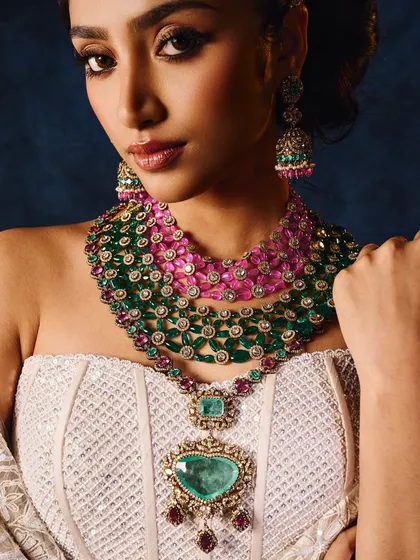 This close-up highlights the stunning color and detail of a multi-layered emerald and ruby necklace. My goal was to make the gemstones feel alive and capture the texture of the heart-shaped pendant for a commercial jewellery shoot.