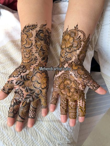 A lovely semi-bridal floral design. The flowers are shaded to create a 3D effect, and the pattern flows beautifully from the fingers to the wrist.