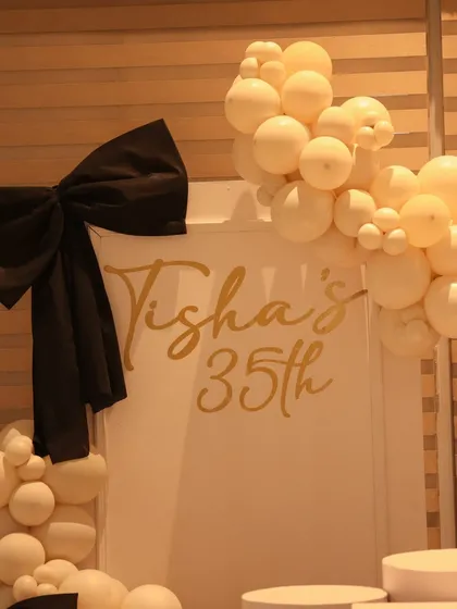 A close up on the custom gold lettering and bow detail from a 35th birthday backdrop. We believe in perfecting these small details that make the decor feel personal and high end.