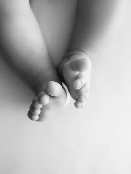 A simple, artistic shot of a baby's feet in black and white. This minimalist approach highlights their tiny, perfect form.