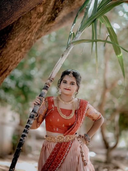 For the Makara Sankranthi festival, I designed this exquisite Zari Kota lehenga for my client. The peach skirt with a traditional border is paired with a red brocade blouse, creating a vision of grace and tradition.