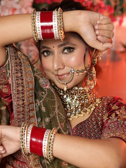 A bridal look featuring a unique olive and maroon lehenga. The close-up on the jewellery and the full-length shot provide a complete picture for stylists.
