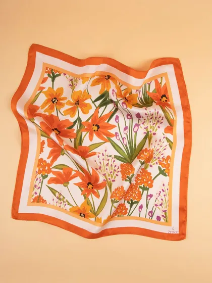 A draped view of the orange floral pocket square, showing the soft texture of the fabric.