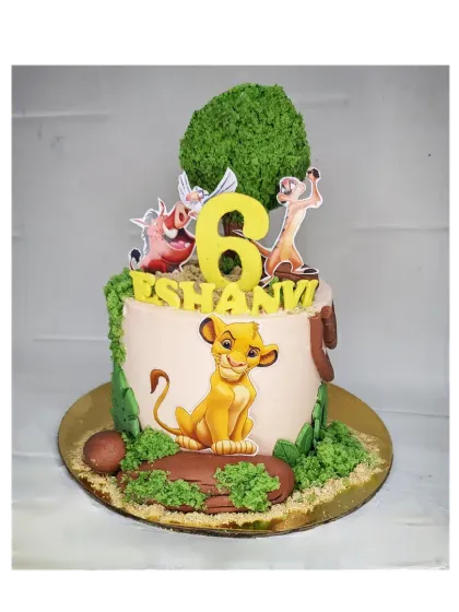 A fun Lion King cake for a 6th birthday. This eggless chocolate truffle cake is decorated with Simba, Timon, and Pumbaa under a tree made of cake crumbs.