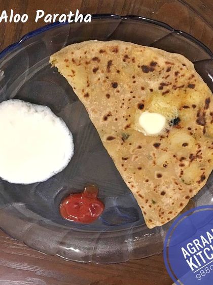 While I specialize in South Indian food, I also make delicious Aloo Parathas. These whole wheat flatbreads are stuffed with a spiced potato filling and served with a dollop of butter and curd.