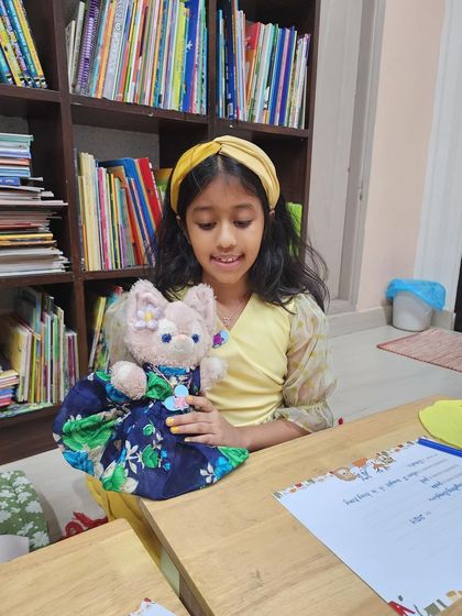 A happy guest with her beautifully dressed furry friend. We encourage children to bring their favorite toys to the party, making the experience even more personal and special.