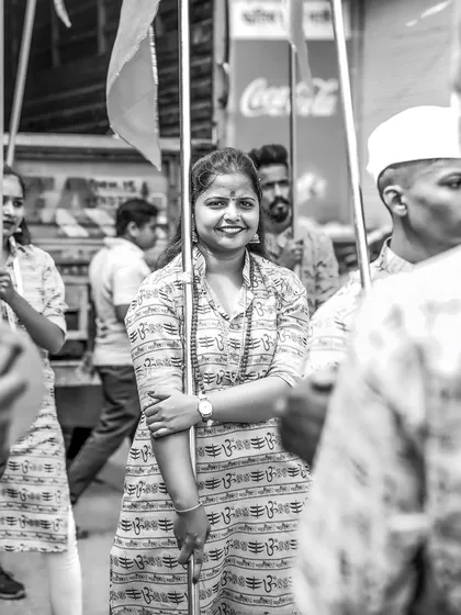 A black and white portrait of the smiling flag-bearer, her joy evident even without color.