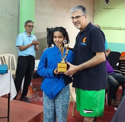 A young winner receiving her trophy.