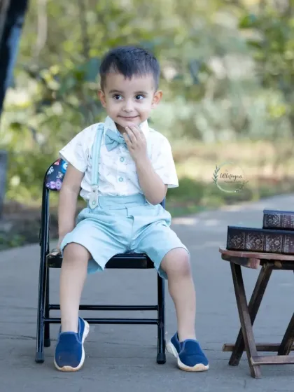 This dapper little boy has a curious and charming expression.