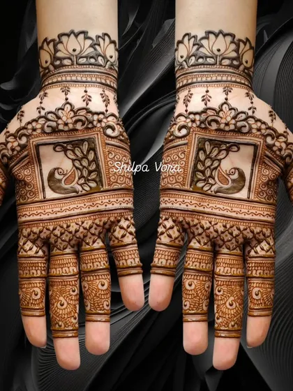 This symmetrical design features peacocks within square frames, a modern take on traditional Karwa Chauth mehndi.