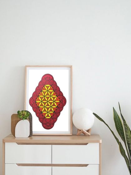 This image shows the mandala framed and placed on a dresser, giving clients an idea of how it can look as a piece of home decor.