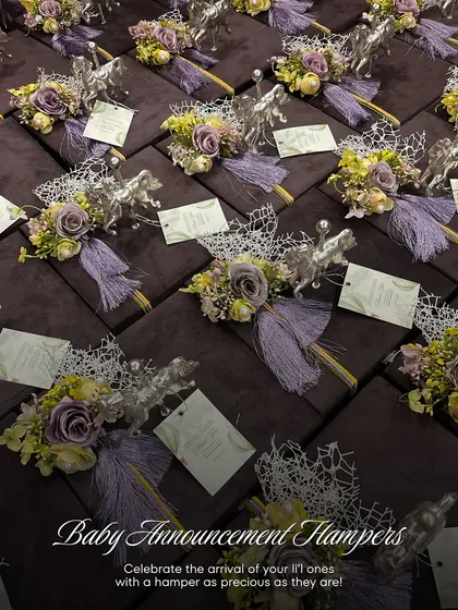 A full set of baby announcement hampers ready for delivery. Each gift is presented in a deep purple velvet box, adorned with a silver horse figurine, a floral bouquet, and a personalized card, perfect for a grand announcement.
