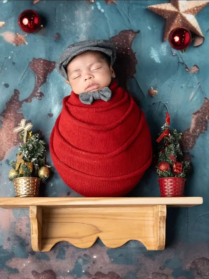 A little gentleman on the shelf. This creative Christmas themed newborn portrait is a unique and charming way to capture your baby's first holiday.