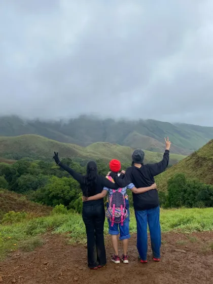 Three friends enjoying the expansive valley views on a private trip to the Nethravathi and Kudremukh region.