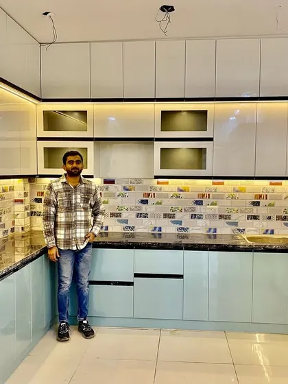 Standing in a newly finished dual-tone kitchen. The combination of light blue and white gives the space a calm and airy feel.