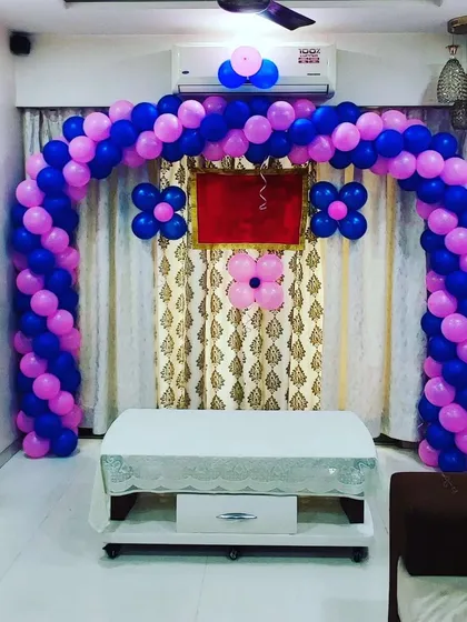 A simple and neat balloon arch in purple and pink. This symmetrical design is perfect for framing a table or entrance for a birthday party or other event.