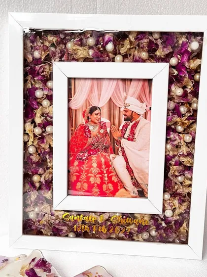 My changeable photo frame is a client favorite. This 13x11 inch frame is filled with preserved purple and gold flowers, ready for the couple to add their favorite wedding photo.
