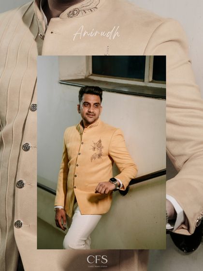 A stylish portrait of the groom in a yellow Jodhpuri jacket. This shot captures his elegant and fashionable look for an engagement or Sangeet ceremony.