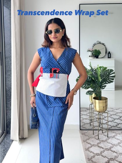 The Transcendence Kimono Wrap Set, a boundless thought translated into fashion. The striped wrap top and skirt feature abstract art details, inspiring you to go beyond your limits.