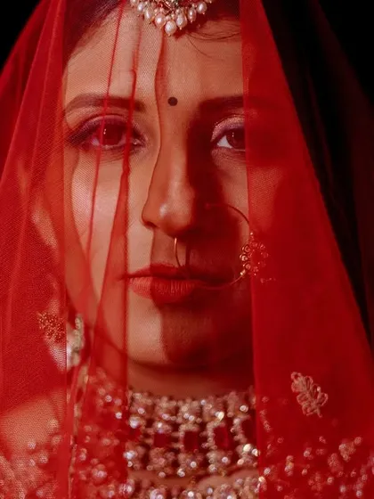 The bride's portrait is a story in itself. Through the traditional red veil, her eyes hold a universe of dreams and anticipation. I use dramatic lighting and composition to create timeless, artistic images that highlight the bride's strength and beauty.