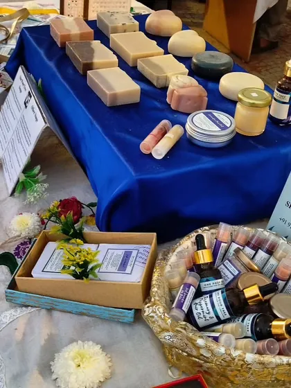 A view of my product display, featuring a variety of soaps, oils, and balms in a golden basket.