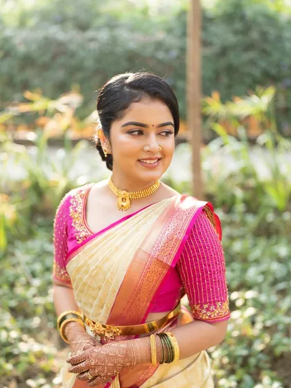 A close-up of the bride's happy face. The makeup is subtle and enhances her natural features, creating a look that is both beautiful and authentic.
