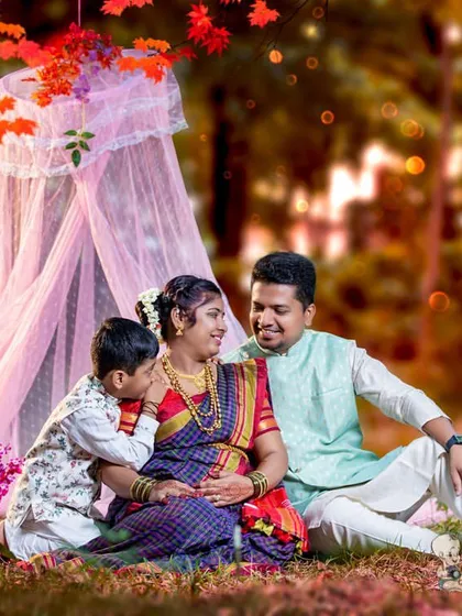 Including the whole family makes a maternity session extra special. Here, an older brother shares a secret with his soon-to-be sibling, creating a beautiful memory in a themed outdoor setup with traditional attire.