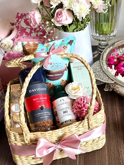 A lovely Rakhi basket for your dearest sister. This gift includes a Zara perfume, waffle crisps, Davidoff coffee, a Body Shop shower gel, and Ferrero Rocher, all beautifully arranged.