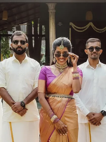 A bride and her groomsmen, all in cool sunglasses, strike a fun and stylish pose.