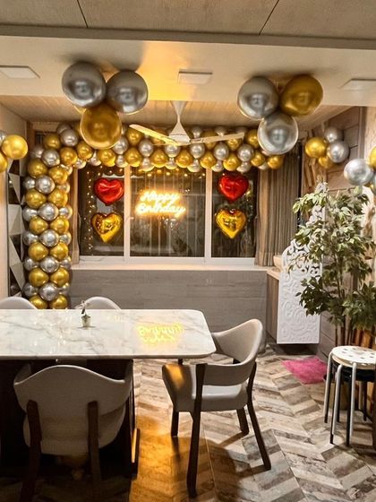 A wider view of the decorated dining space, showing how even a simple setup can transform a room for a celebration.